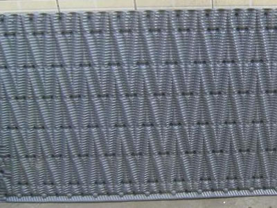 One piece of gray cooling tower fill is leaned upon the wall, the configuration of the raising surface is w wave.